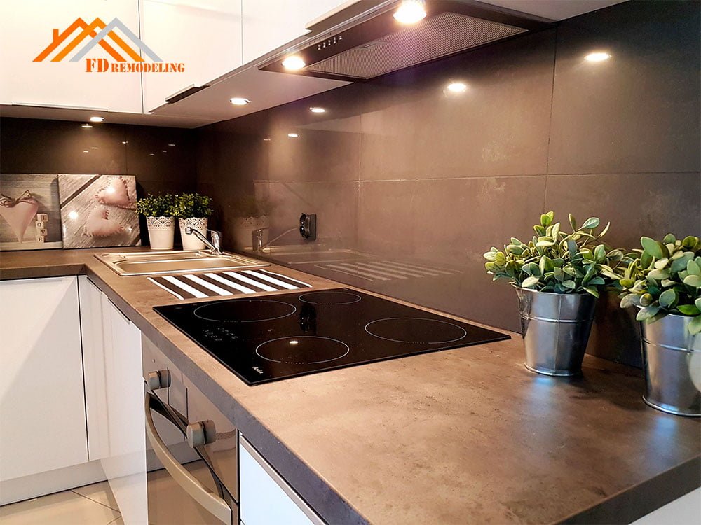 A kitchen with a stove and a potted plant.