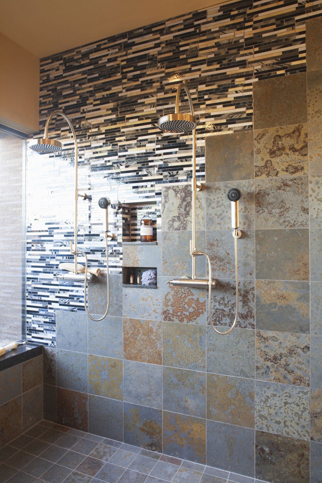 A bathroom with tiled walls and a shower.