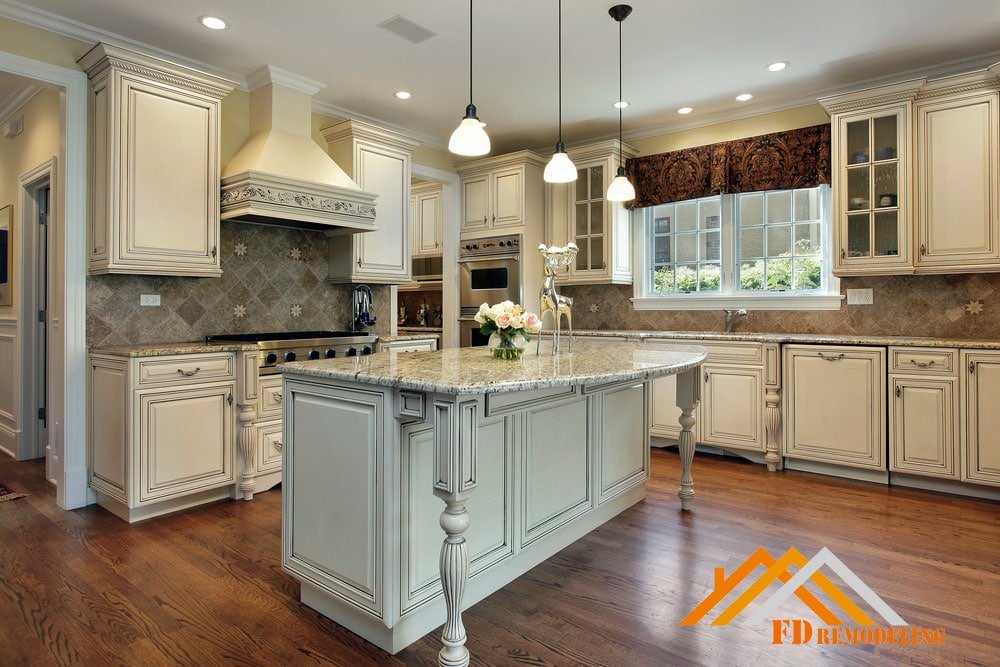 A kitchen with white cabinets and a center island.