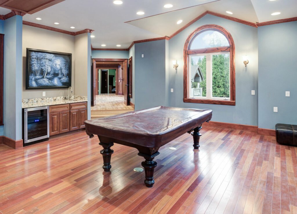 A pool table in a room with blue walls.