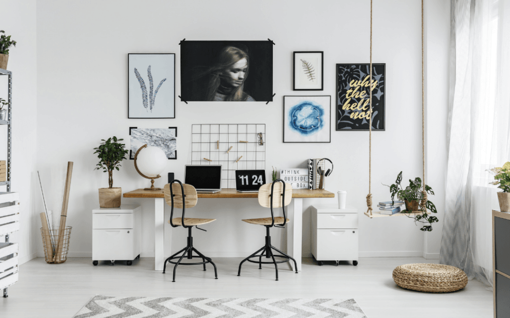 A white and black home office with a lot of pictures on the wall.