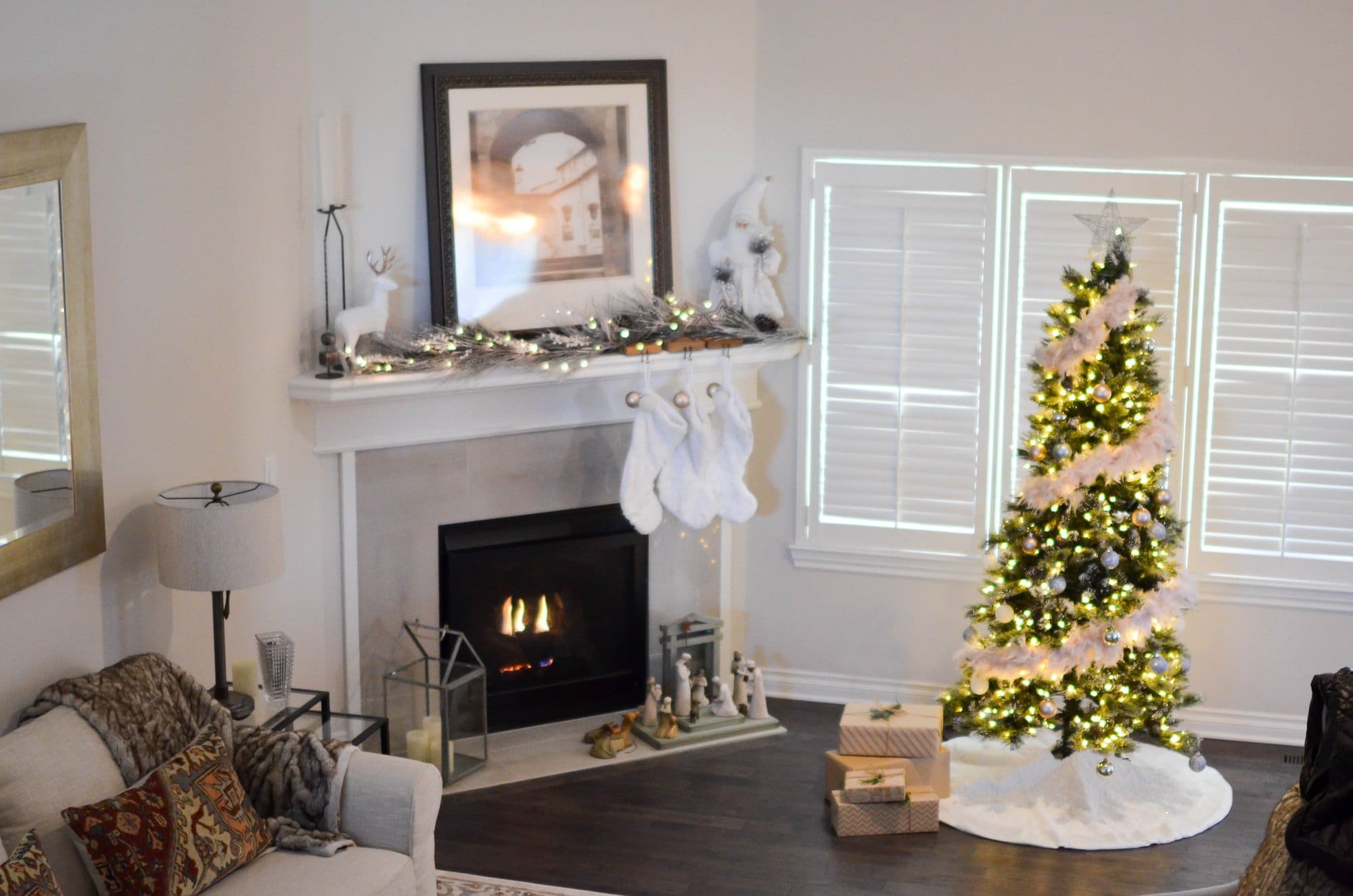 A living room with a christmas tree and stockings.