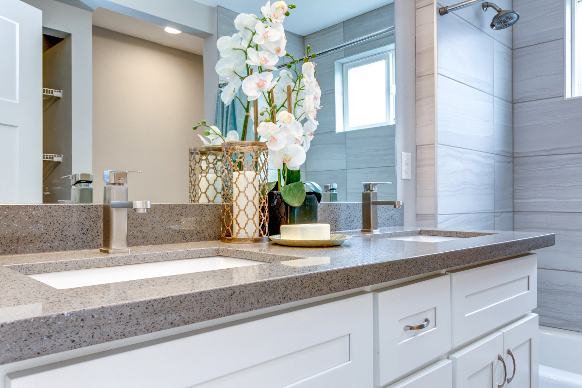 A bathroom with two sinks and a mirror.