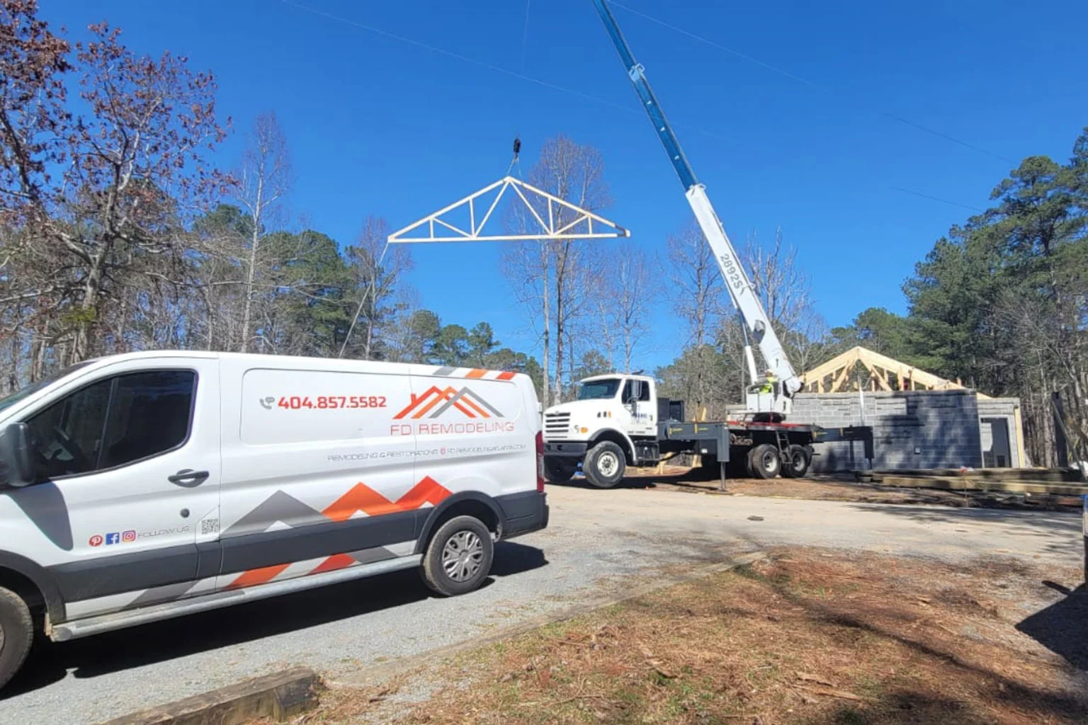 A white van with a crane attached to it, a dynamic content widget.