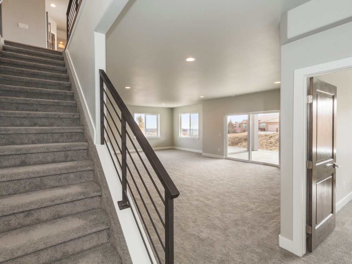 A finishing staircase in a basement of a house.