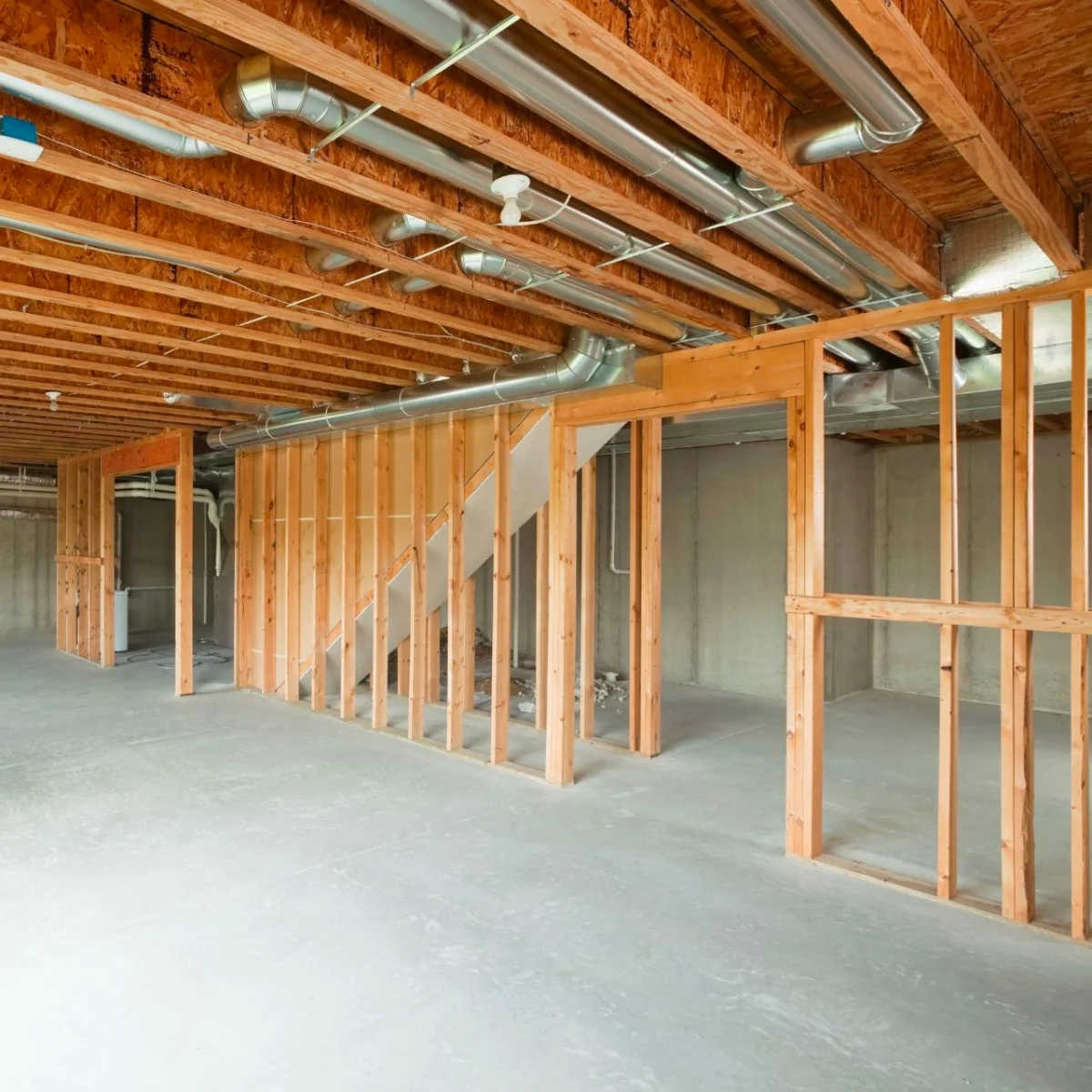 An unfinished basement with wood framing, ready for finishing.