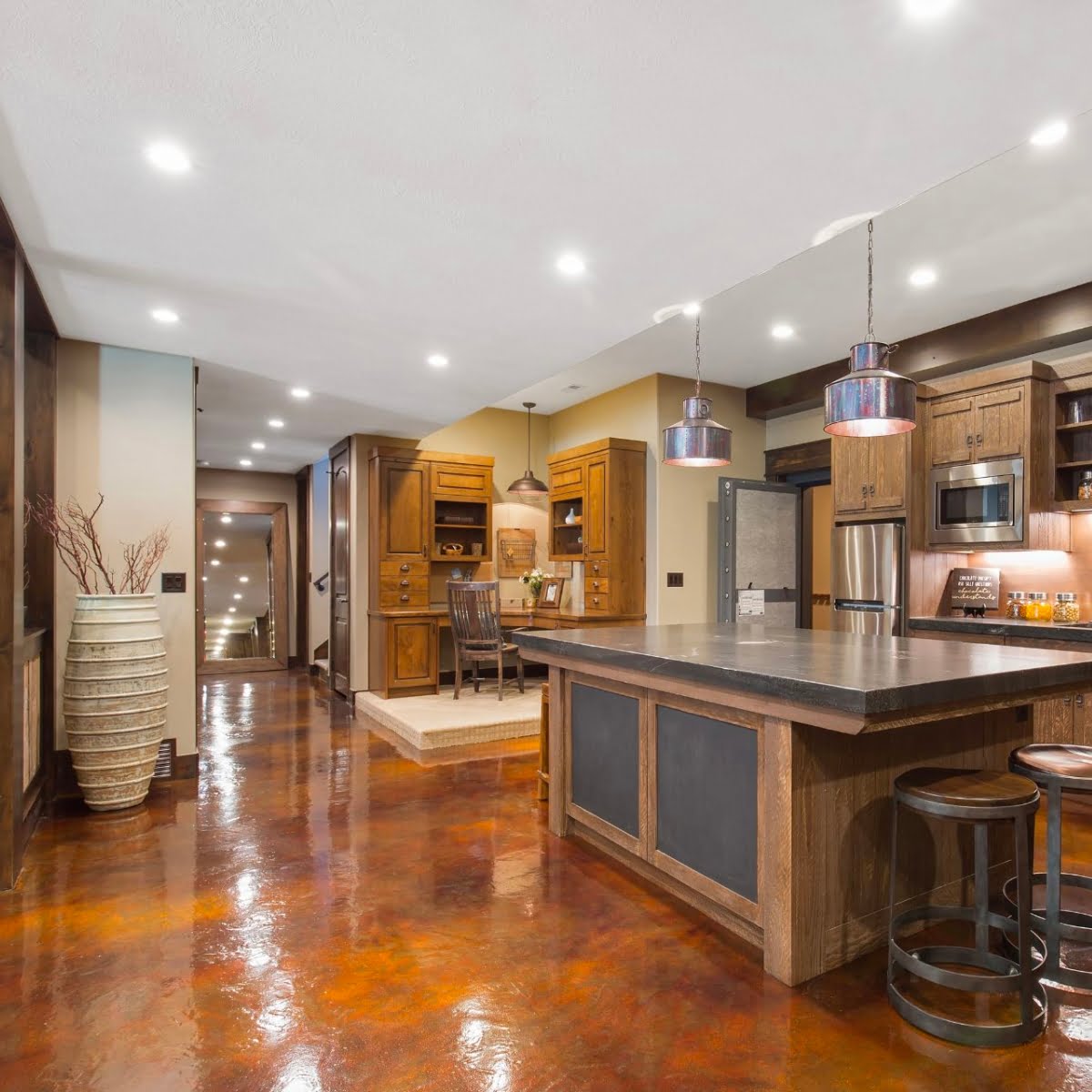 A large kitchen with a center island and bar stools, perfect for finishing your basement.