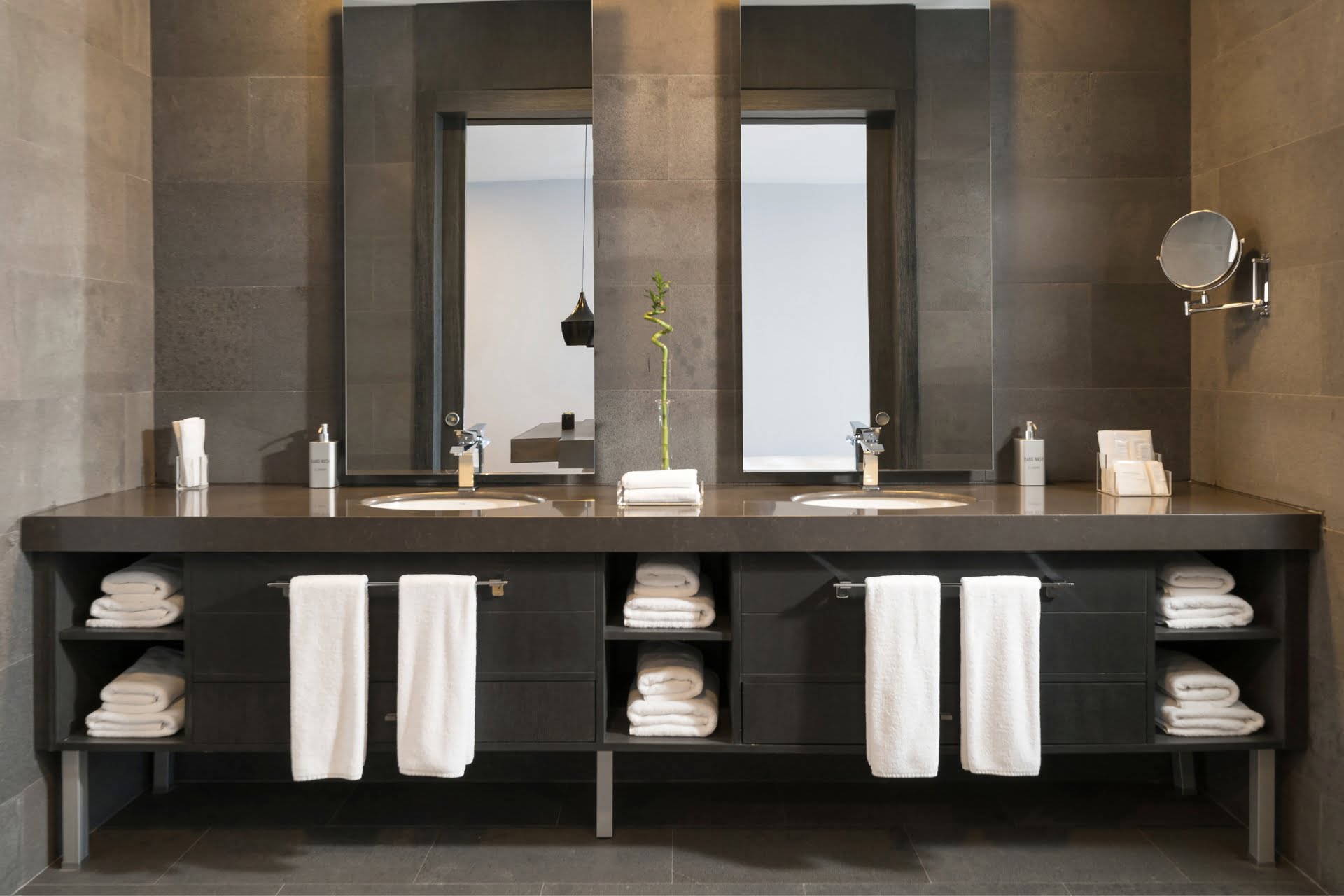 A commercial bathroom with two sinks and two mirrors.