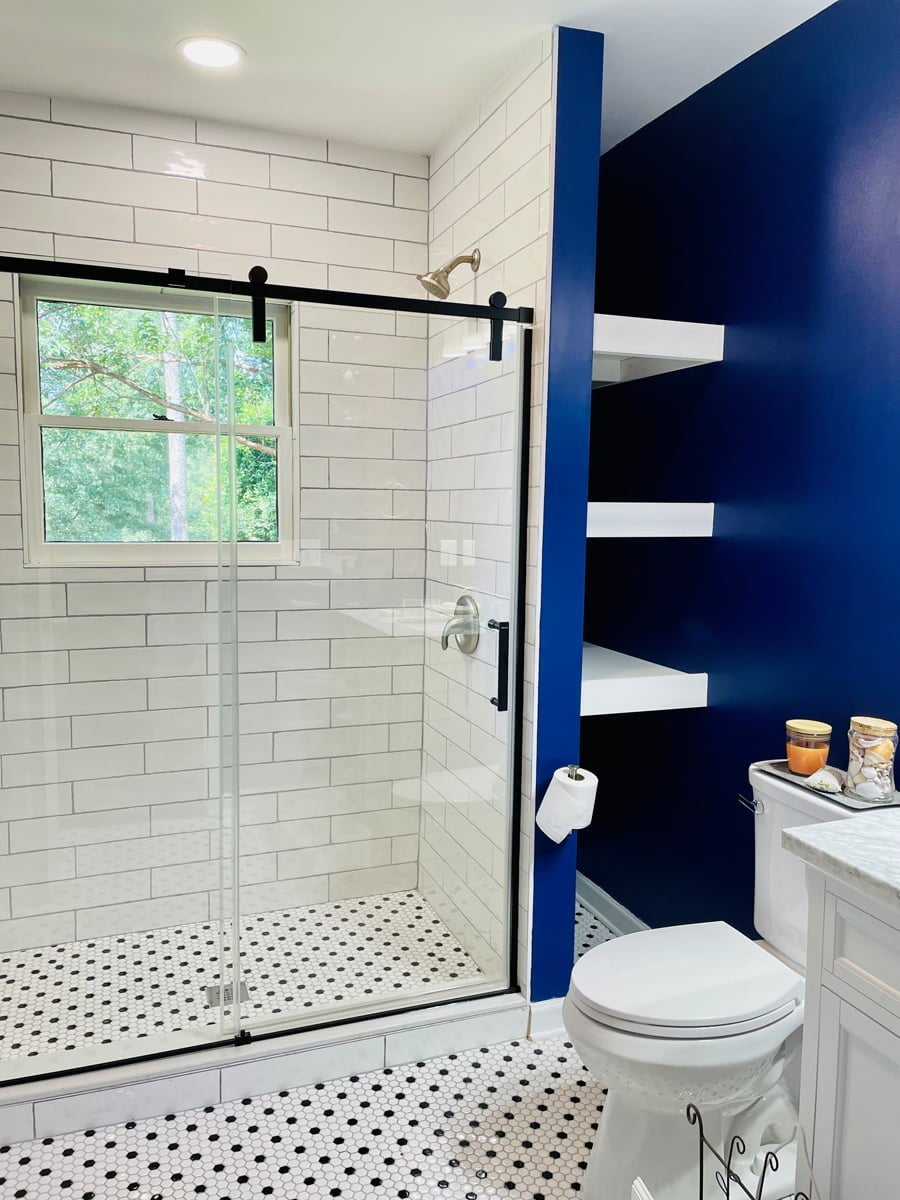 Home Remodeling in Marietta GA 1 A vibrant blue and crisp white bathroom, boasting a sleek glass shower door, in a cozy home.
