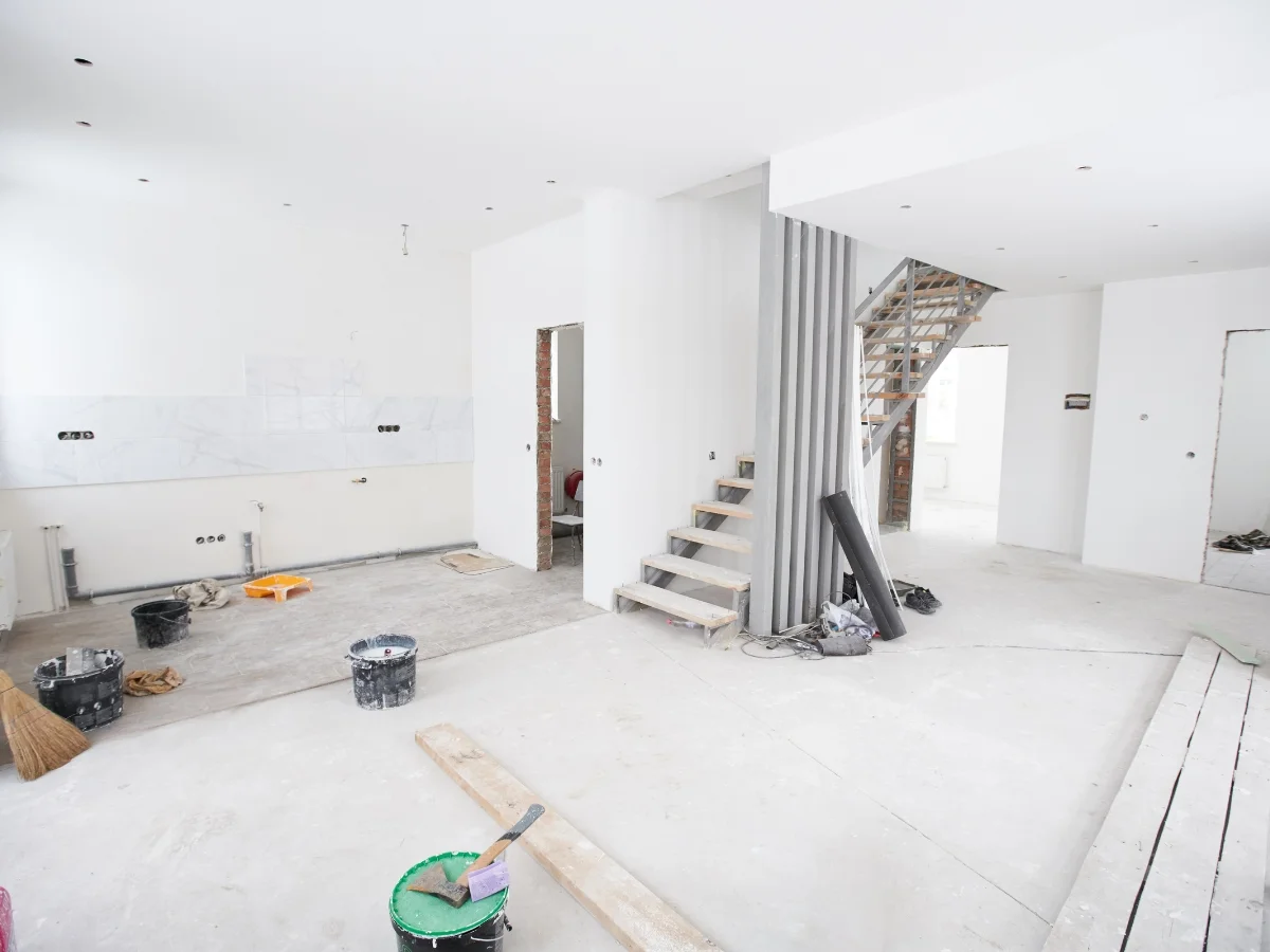 A basement that is being remodeled with a staircase for finishing.