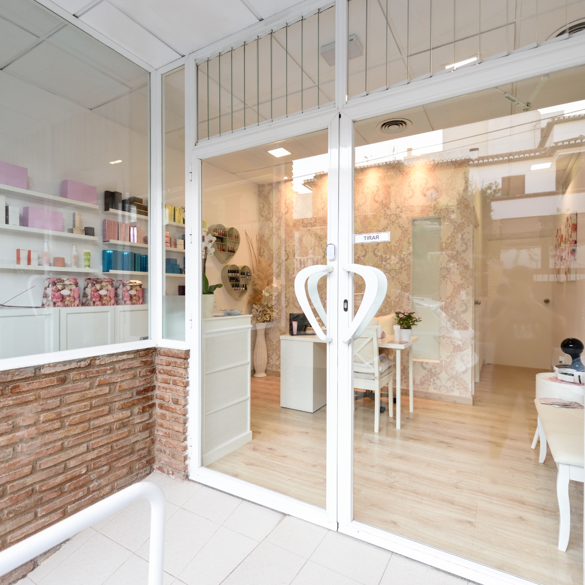 The newly remodeled retail store entrance to a beauty salon with a glass door.