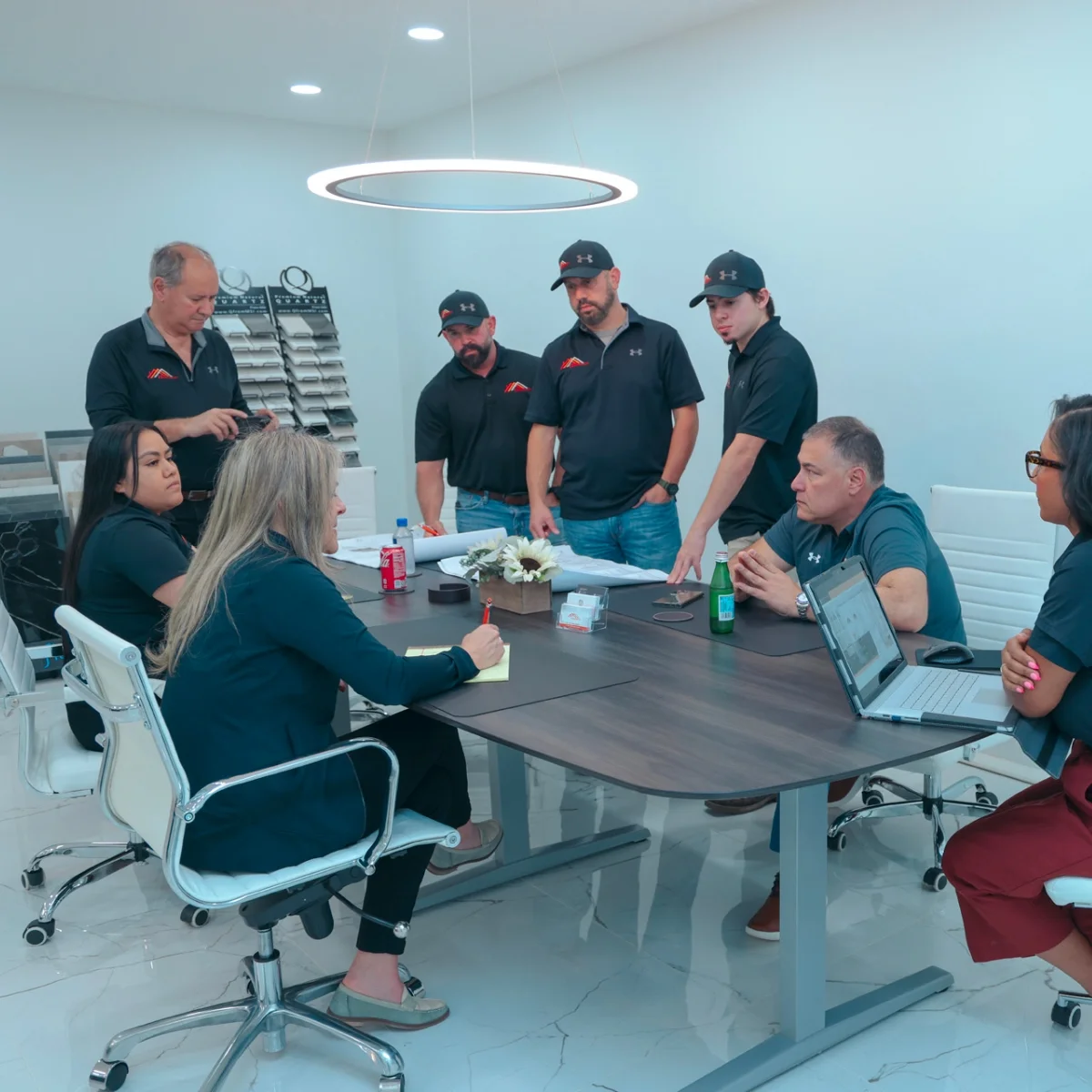 A group of people sitting around a table discussing retail store remodeling plans.