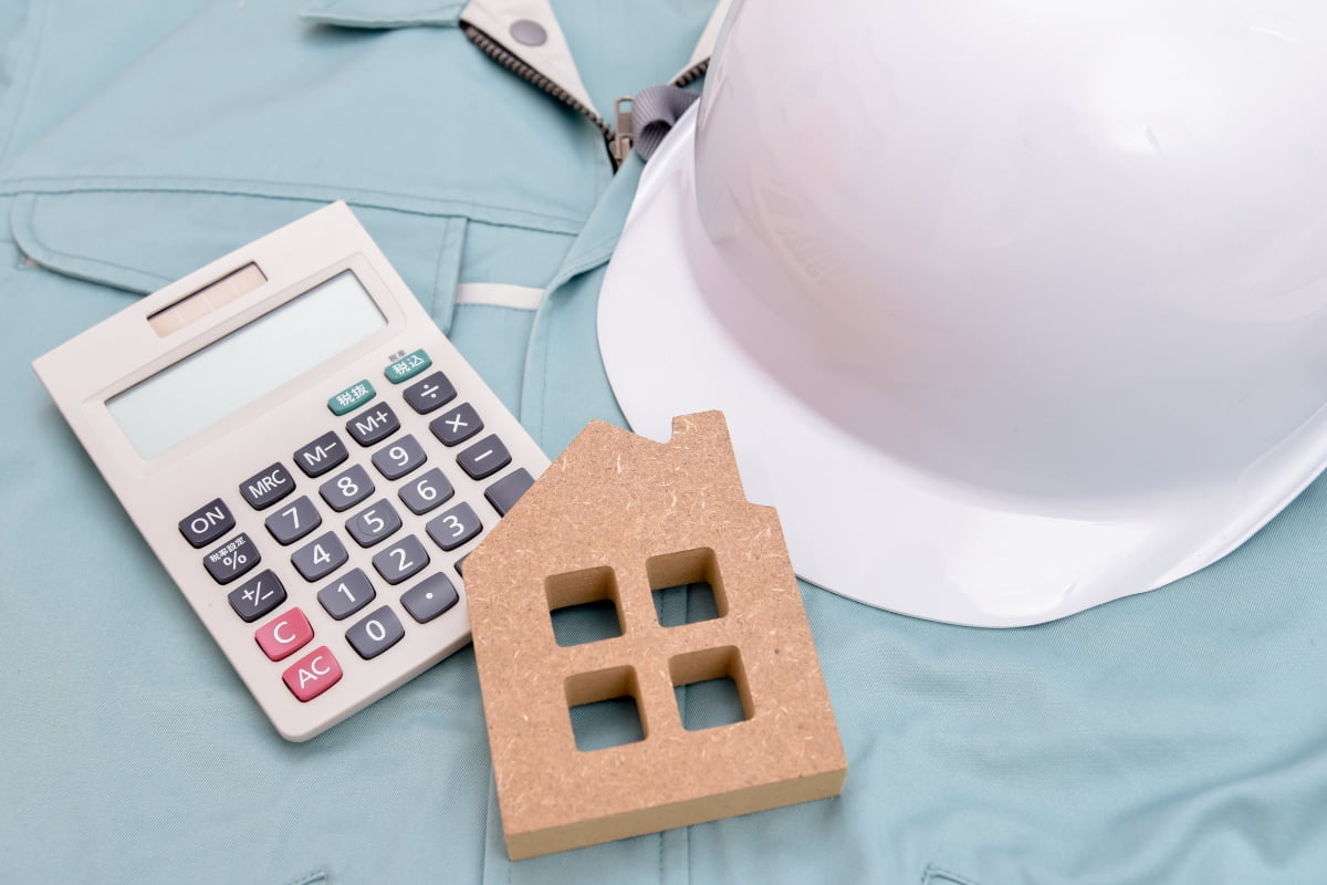 A small house on a blue shirt, perfect for calculating your remodeling budget.