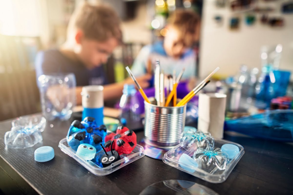 A group of kids painting on a table while keeping within a remodeling budget.