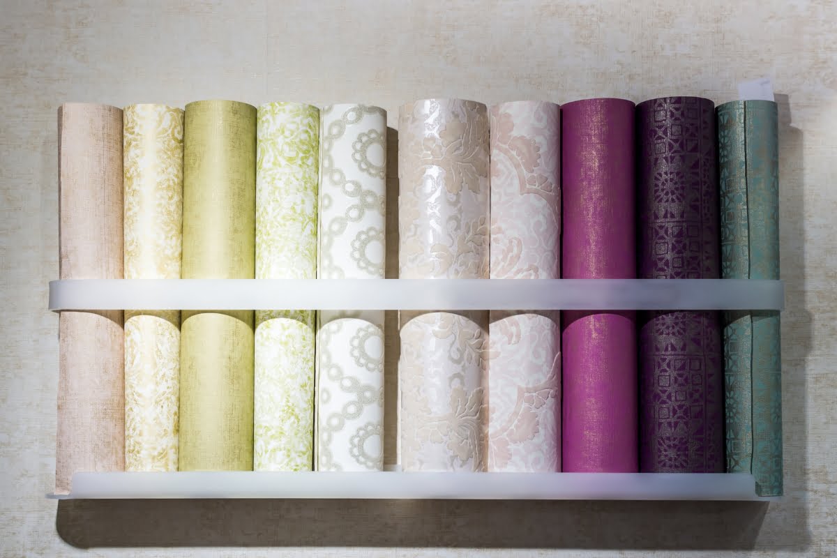 A shelf with rolls of wallpaper for bedroom focal wall ideas.