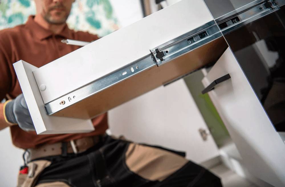 A man holding a white drawer.