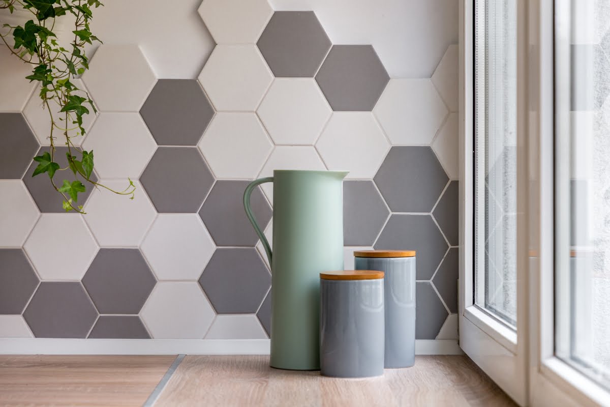 A vase and jars on a bedroom focal wall table.