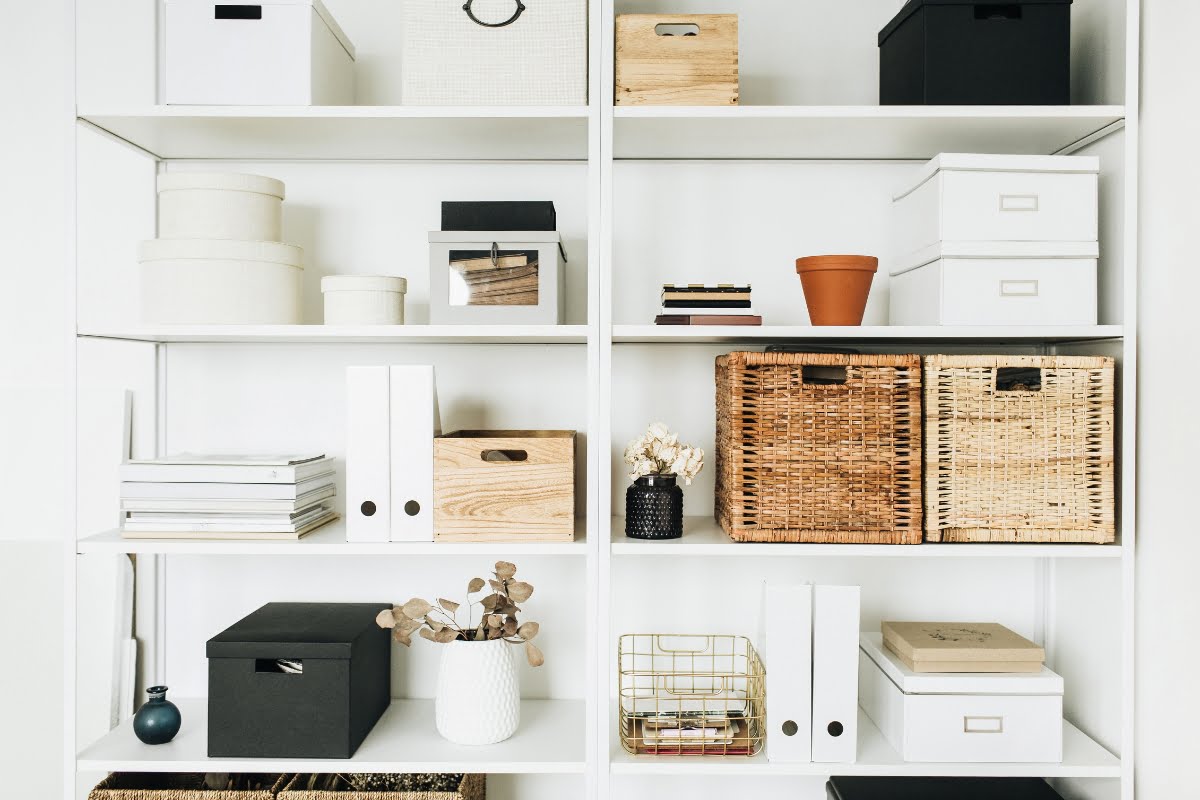 A neatly organized shelving unit with various storage boxes, baskets, and containers of different shapes, sizes, and materials—perfect for any DIY home improvement enthusiast.