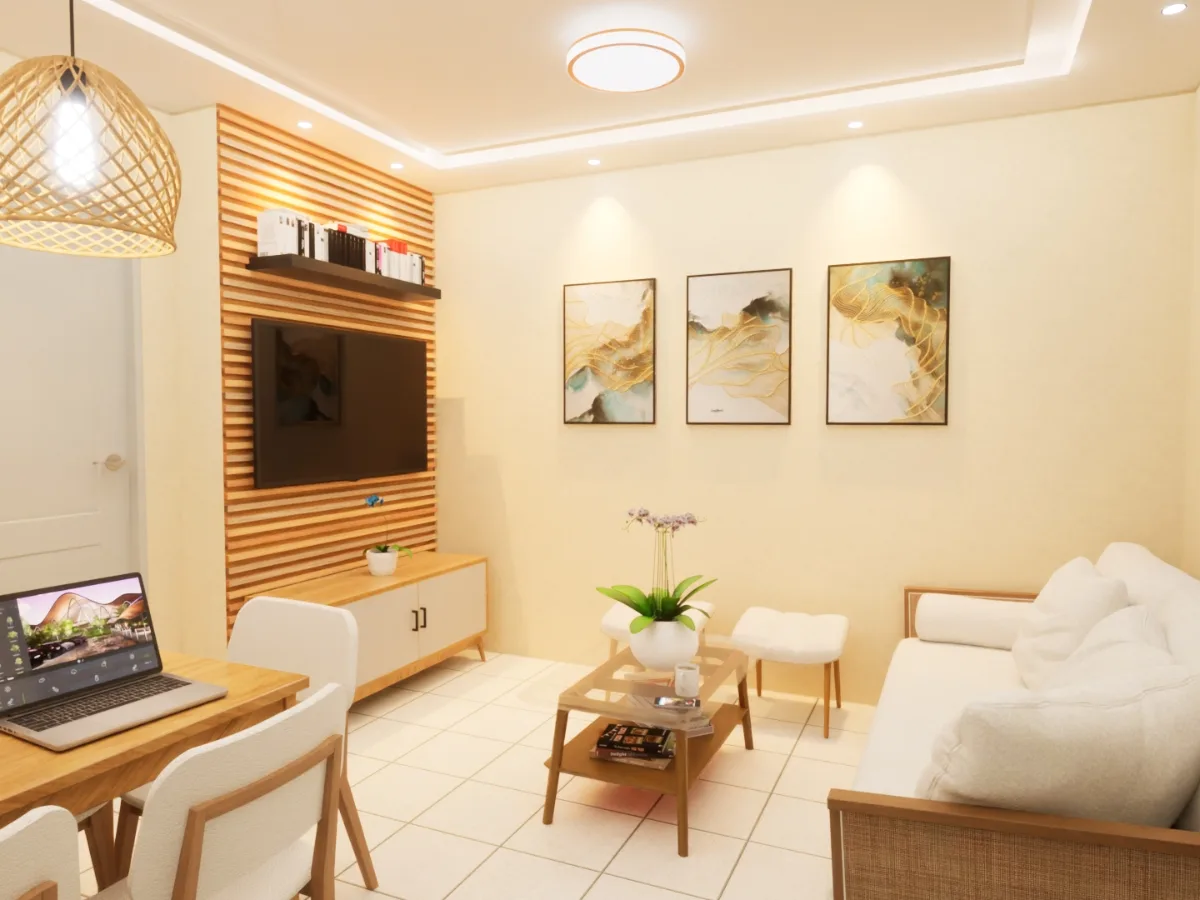 A modern living room, recently refreshed through condo remodeling, features a white sofa, wooden furniture, a wall-mounted TV, three abstract paintings, and a dining table with a laptop on it.