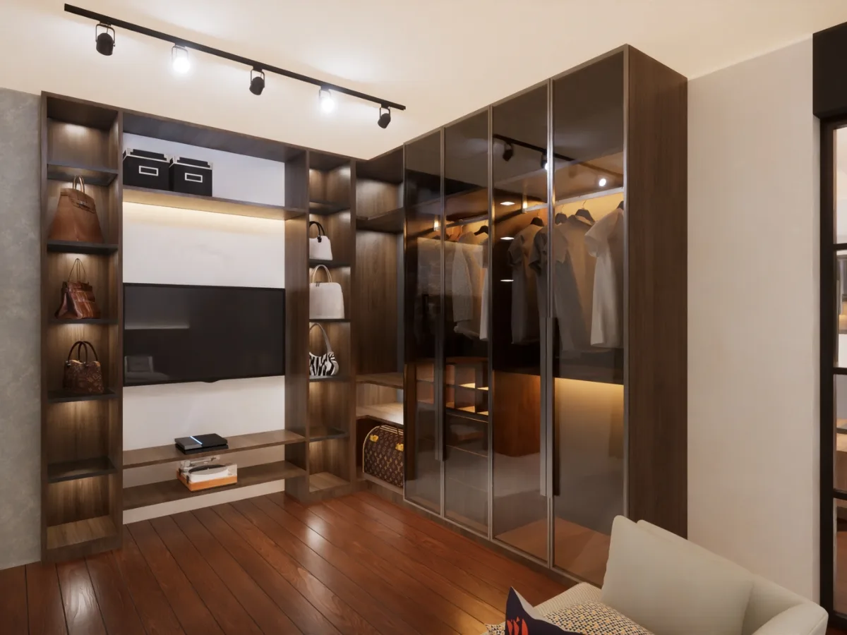A modern walk-in closet by custom closet designers features wooden shelves, glass cabinets, hanging clothes, handbags, and storage boxes, all beautifully illuminated by ceiling track lights.