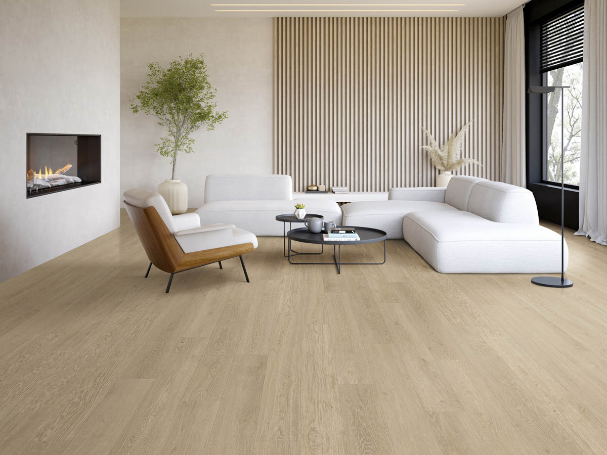 Achieving a Minimalist Design in Your Home Remodel 1 Modern living room with light wood flooring, white sectional sofa, armchair, round coffee tables, fireplace, large plant, and slatted wood accent wall embraces a minimalist design for a clean and inviting atmosphere.