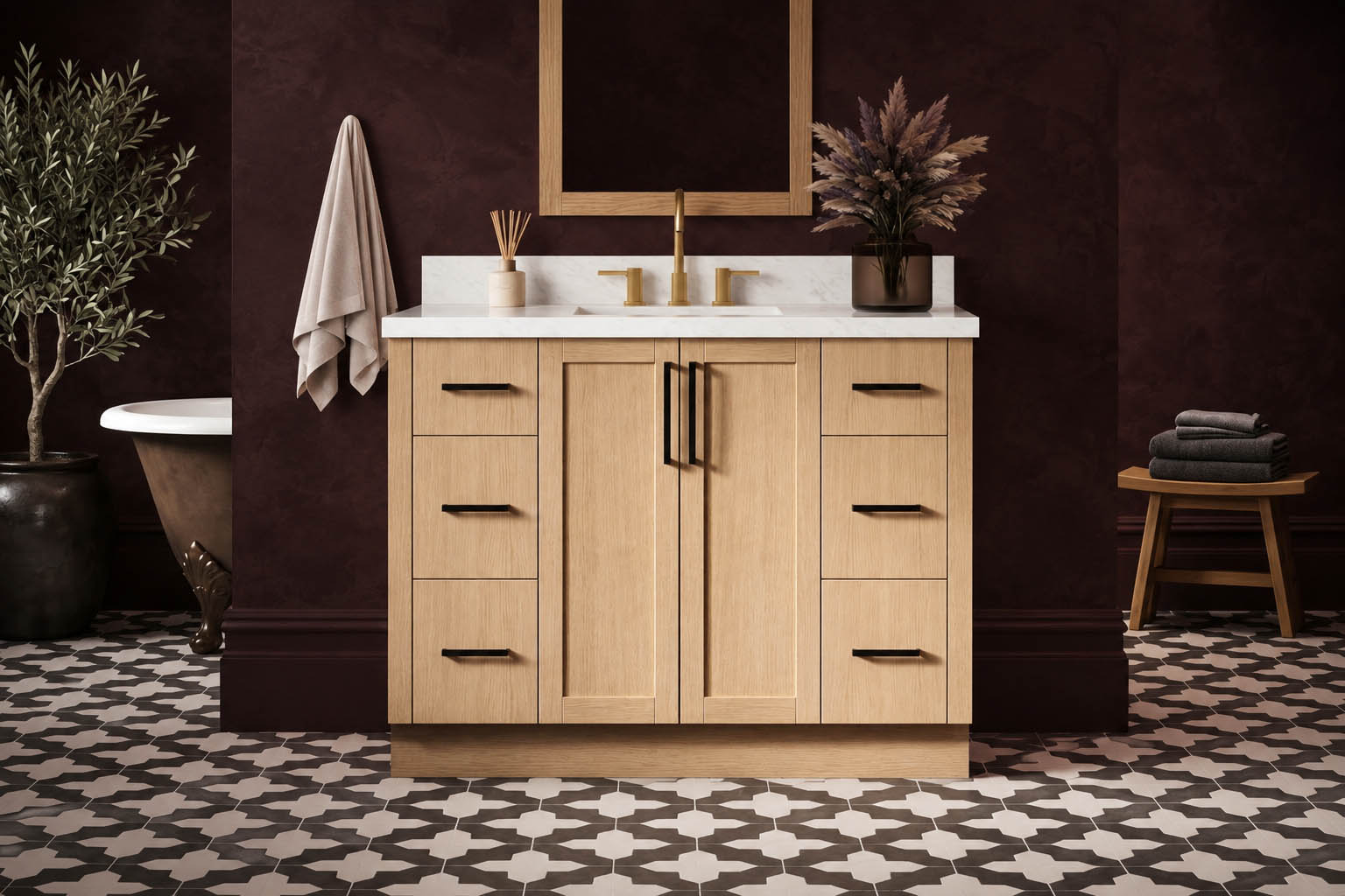 Light wood bathroom vanity with a white countertop, gold faucet, wall-mounted mirror, and decorative items. Dark red walls, patterned tile floor, towel, and plant complete the setting—perfect inspiration for a stylish bathroom renovation or a business restroom upgrade.