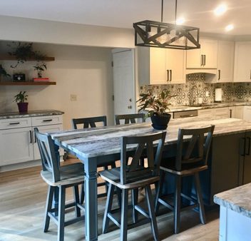 A kitchen with a center island and bar stools.