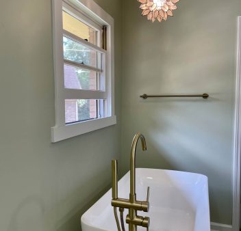 A bathroom with a bathtub and a window.