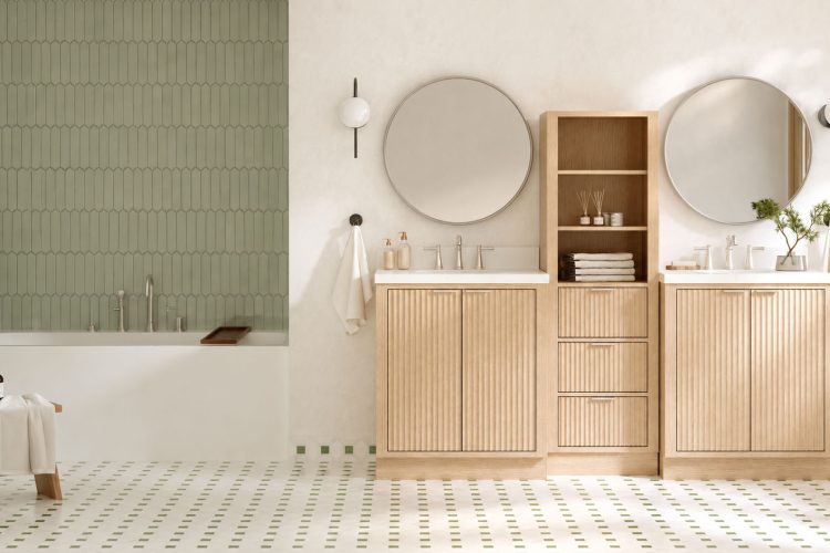 Modern bathroom with a tub, green tile accent wall, double vanities with round mirrors, wooden cabinets, and patterned floor tiles—an ideal inspiration for an office restroom transformation that combines style and functionality.
