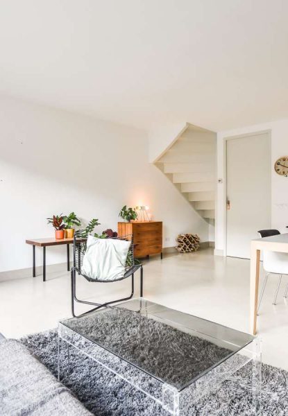 A living room with a wooden table and chairs.