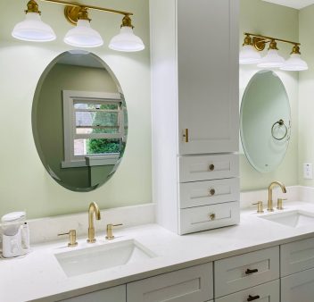 A home bathroom with two sinks and a mirror.