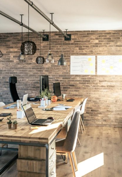 A commercial office with wooden walls and a wooden desk.